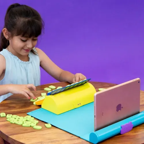 Play Shifu Plugo Letters-kit med blå matta, surfplatteställ och gul hållare, bokstavsbrickor spridda, barn leker vid bord.